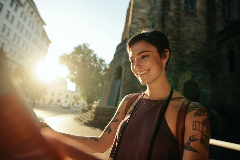 a-woman-looking-at-a-map-smiling