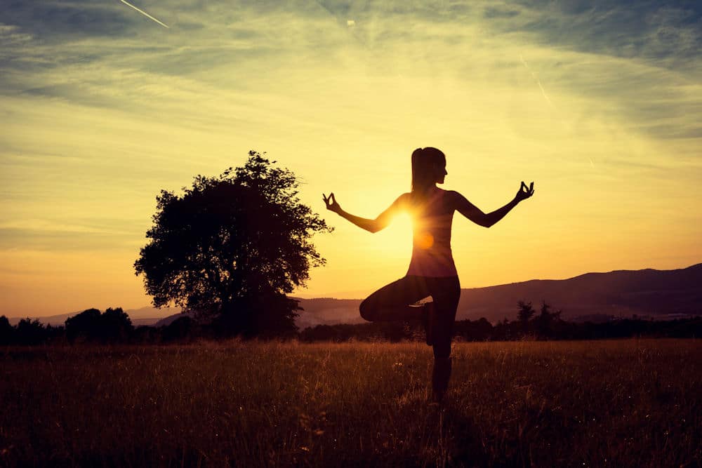 a-woman-outside-practicing-yoga