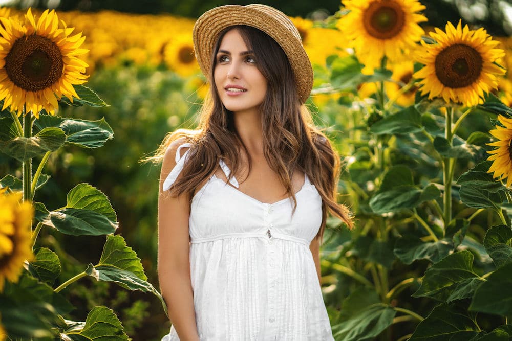 a-woman-outside-surrounded-by-sunflowers