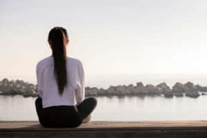 a-woman-meditating-on-the-beach