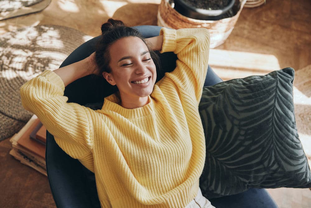 a-woman-smiling-relaxing-on-the-chair