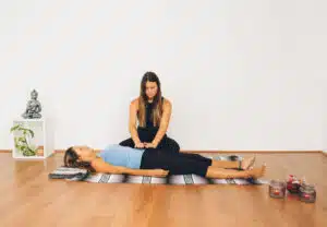 a woman doing reiki for another woman