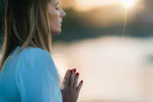 a-woman-praying-and-meditating-outside