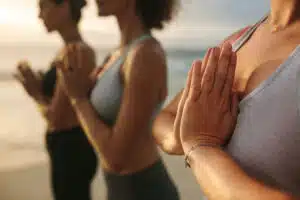 women-practicing-yoga-on-the-beach