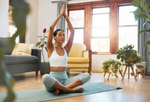 woman doing yoga in living room