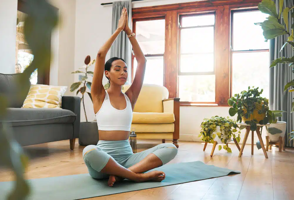 woman doing yoga in living room