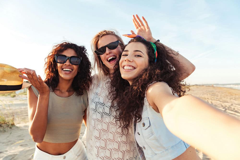 three-women-taking-a-picture-on-the-beach