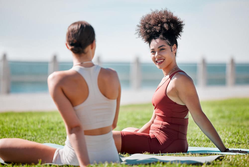 two woman sitting at the park