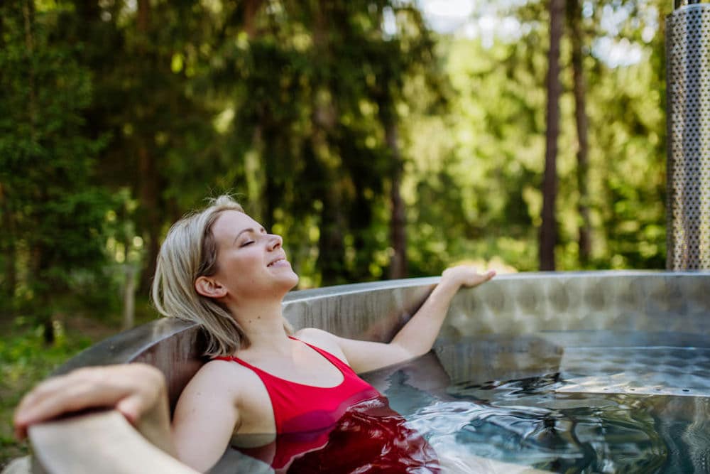 a-woman-smiling-relaxing-in-a-hot-tub