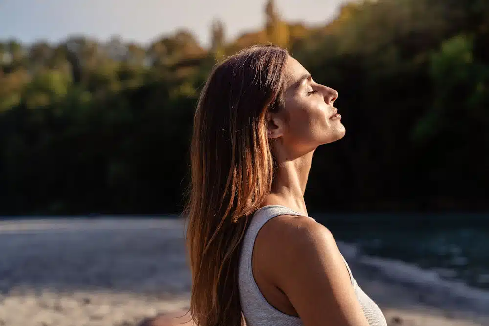 a-woman-meditating-in-the-sun-during-the-summer