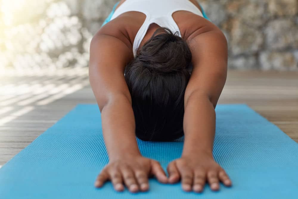 a-woman-stretching-on-a-yoga-mat