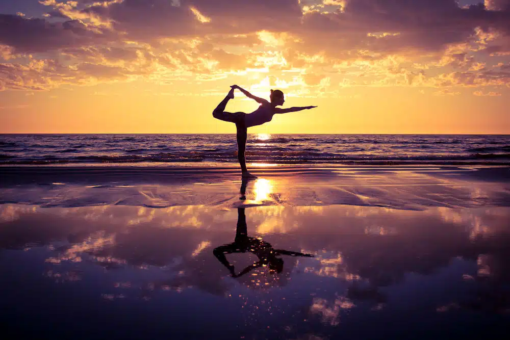 woman-practicing-yoga-during-the-sunset