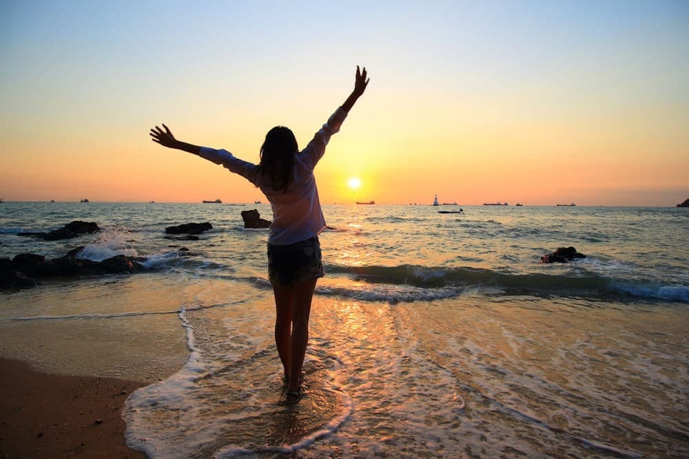 a-woman-embracing-recovery-on-the-beach