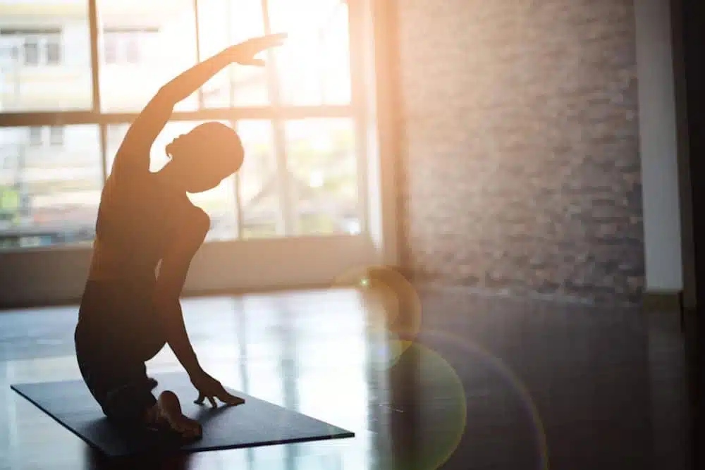 a woman practicing yoga alone