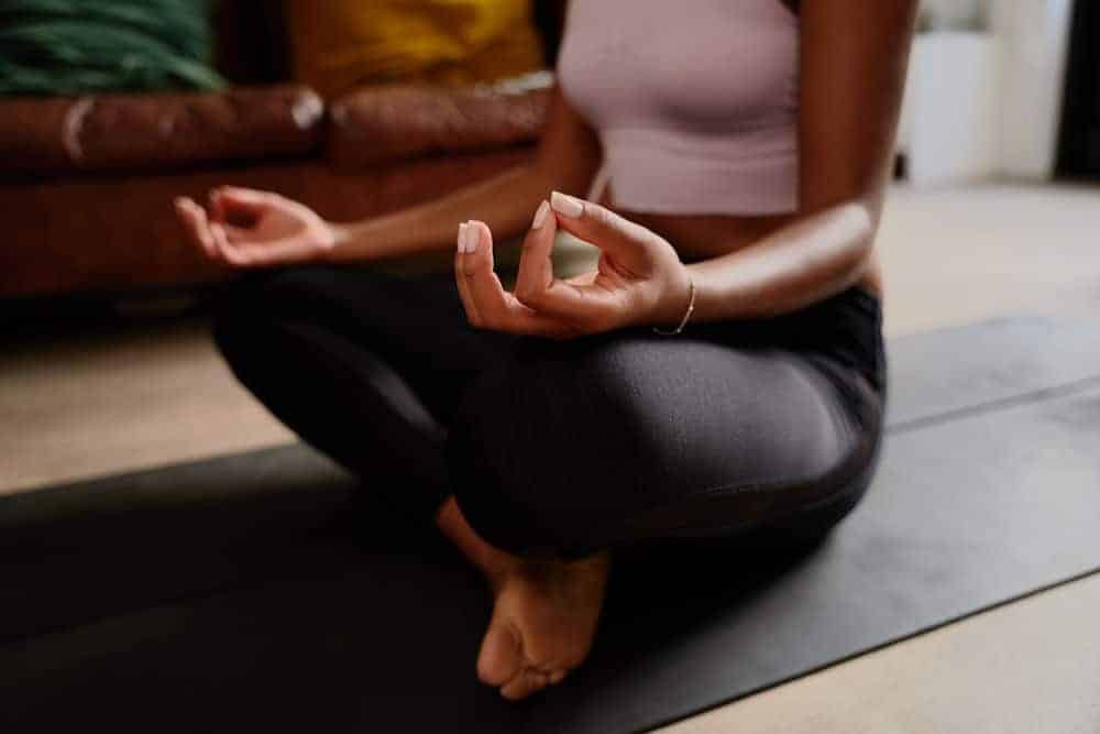 a woman practicing yoga on a yoga mat