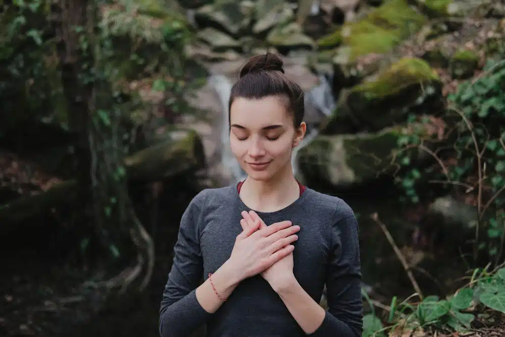 a-woman-meditating-in-the-forest