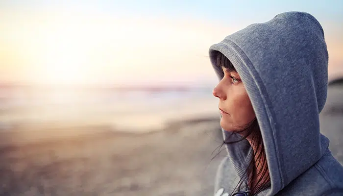 a-woman-staring-out-at-the-beach