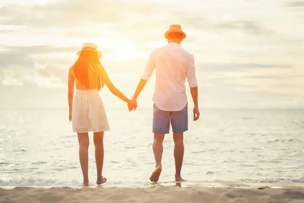 A Couple Holding Hands on the Beach