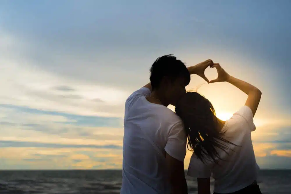 A Couple on the Beach Watching the Sunset