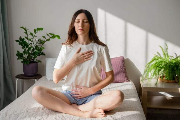 A Woman Meditating on the Bed Meditating