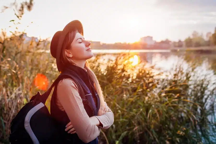 a woman with her eyes closed in nature