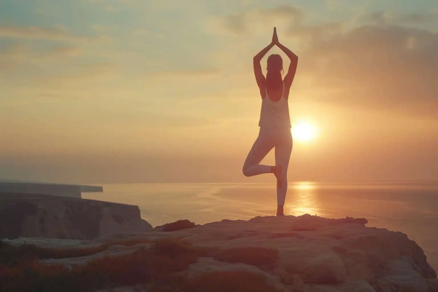 a woman practicing yoga outside